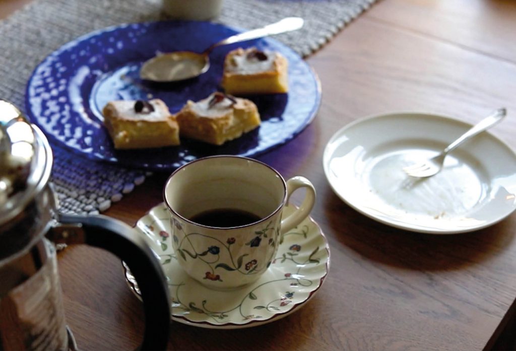 Närbild över uppdukat fikabord med kaffe och hembakta kakor under en återträff för en Livsnära samtalsgrupp där flera av deltagarna, äldre personer över 62 år, lärt känna nya vänner och fortsatt att ses tillsammans efter sista träffarna med samtalsgruppen.